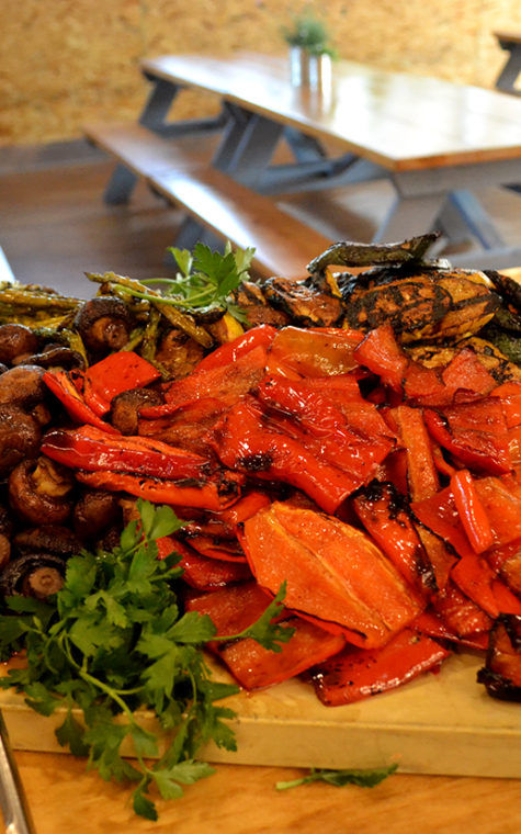 Assorted roasted veggies, including mushrooms and sweet red bell peppers.