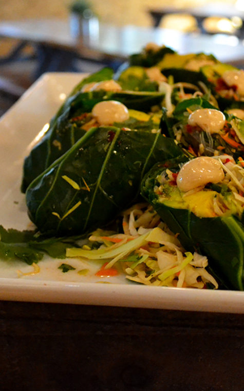 Collard green spring rolls are filled with carrot, avocado, cabbage and kelp noodles in a citrus vinaigrette.