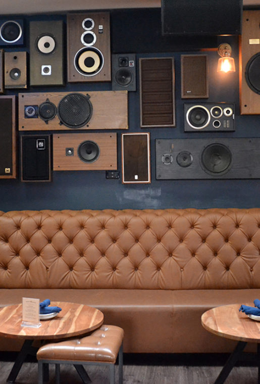 Upstairs decor at Next Door is all about the music. Check out their wall filled with speakers. You won’t ever miss the beat.